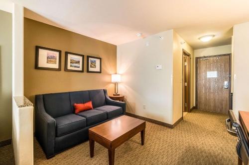 a living room with a couch and a table at Comfort Inn & Suites Rifle in Rifle