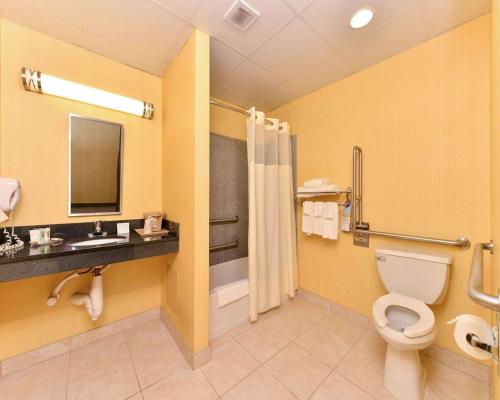 a bathroom with a toilet and a sink at Quality Suites Stratford in Stratford