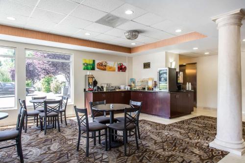 a restaurant with tables and chairs and a counter at Quality Inn & Suites Danbury near University in Danbury