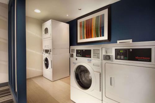a laundry room with a washer and dryer at Comfort Inn Downtown DC-Convention Center in Washington