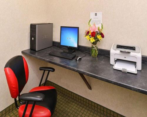 a desk with a computer and a printer at Quality Suites Stratford in Stratford