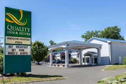 a gas station with a sign in front of it at Quality Inn & Suites Danbury near University in Danbury