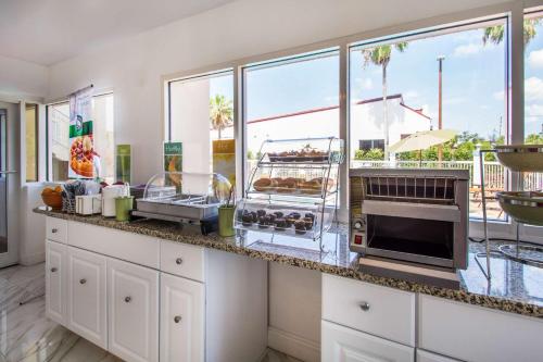 a kitchen with a counter with some food on it at Quality Inn Clermont West Kissimmee in Kissimmee