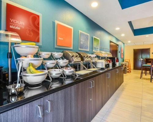 a buffet line with bowls and bananas on it at Comfort Suites Tampa - Brandon in Tampa