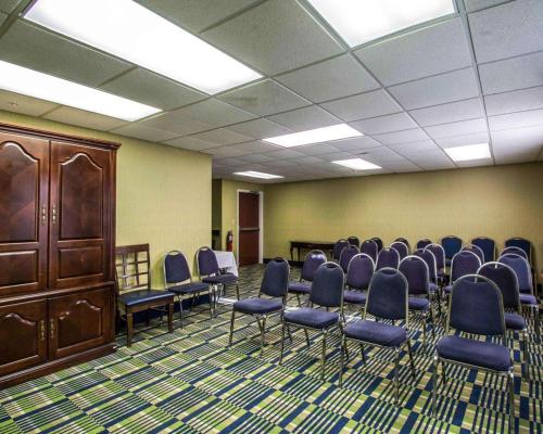 a conference room with chairs and a wooden cabinet at Comfort Inn & Suites Lantana - West Palm Beach South in Lantana