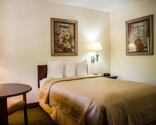 a hotel room with a bed and a table at Quality Inn Crystal River in Crystal River