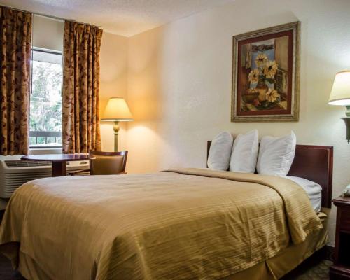 a hotel room with a bed and a window at Quality Inn Crystal River in Crystal River