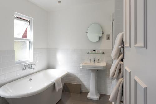 a white bathroom with a tub and a sink at Best Western Red Lion Hotel in Salisbury