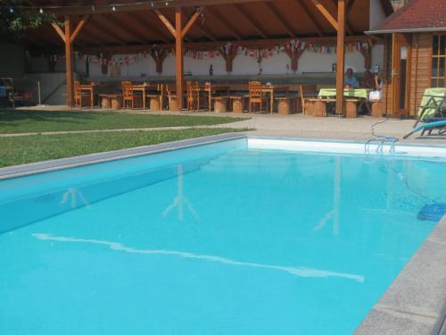 a large blue swimming pool with a table and chairs at Gasthof Maly in Mauthausen