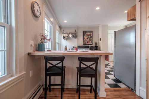 a kitchen with two stools at a kitchen island at Haven on the Hill in Portland