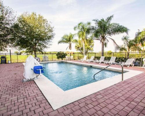 a swimming pool with a water hose at Sleep Inn Fort Pierce I-95 in Fort Pierce