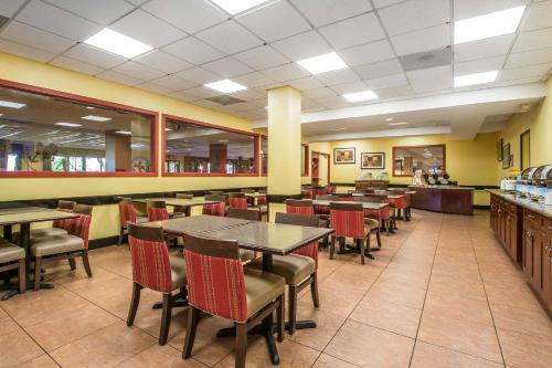 a dining room with tables and chairs in a restaurant at The Adventure Hotel by the Parks in Orlando