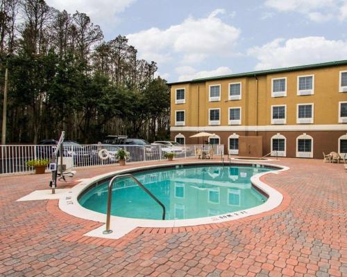 a swimming pool in front of a building at Sleep Inn & Suites Orlando International Airport in Orlando