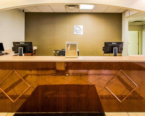 a lobby with a counter with a laptop on it at Sleep Inn & Suites Orlando International Airport in Orlando