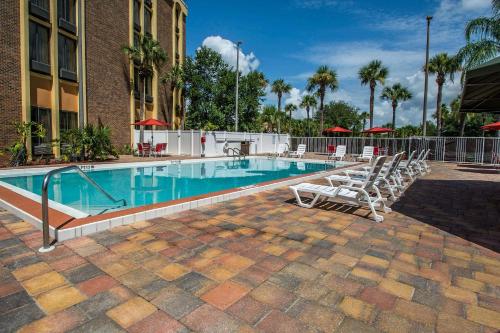 a swimming pool with lounge chairs next to a building at The Adventure Hotel by the Parks in Orlando