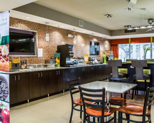 a restaurant with a table and chairs and a counter at Quality Suites Fort Myers I-75 in Fort Myers
