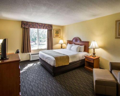 a hotel room with a bed and a television at Comfort Inn & Suites Jupiter I-95 in Jupiter