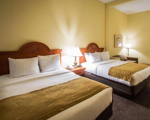a hotel room with two beds and a lamp at Comfort Inn & Suites Jupiter I-95 in Jupiter