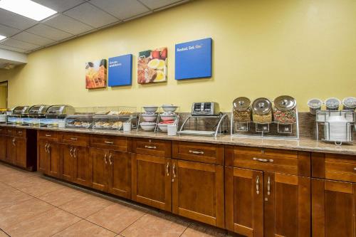 a buffet line in a cafeteria with food on it at Comfort Inn Kissimmee by the Parks in Orlando