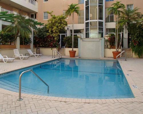 a large swimming pool in a apartment complex at Rodeway Inn South Miami - Coral Gables in Miami