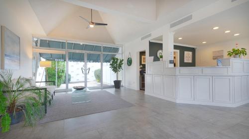 a large living room with white cabinets and potted plants at East Hampton House Resort in East Hampton