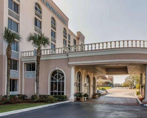 a large building with palm trees in front of it at Comfort Inn & Suites Lakeland North I-4 in Lakeland