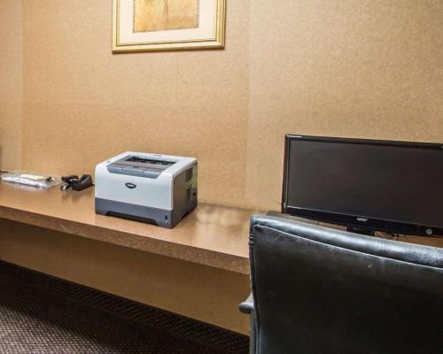 a desk with a computer and a printer and a tv at Comfort Inn & Suites Jupiter I-95 in Jupiter