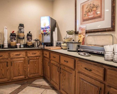 a kitchen with wooden cabinets and a counter top at Quality Inn Lake City in Lake City
