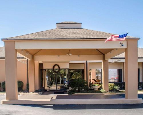 a building with an american flag on top of it at Quality Inn & Suites Pensacola Bayview in Pensacola