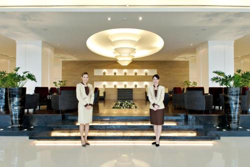two women standing in the lobby of a hotel at The Narathiwas Hotel & Residence Sathorn Bangkok in Bangkok