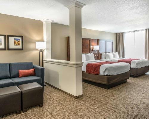 a hotel room with two beds and a couch at Comfort Suites Dunnellon near Rainbow Springs in Dunnellon
