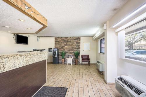 a lobby with a bar and a tv in a building at Bay Inn in Tampa