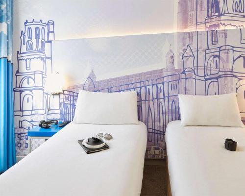a bedroom with two beds with rings on them at B&B HOTEL Albi in Albi