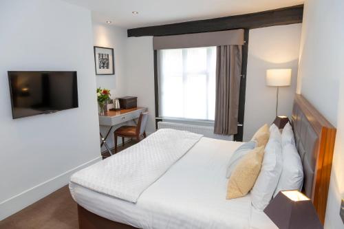 a hotel room with a bed and a television at Best Western Red Lion Hotel in Salisbury
