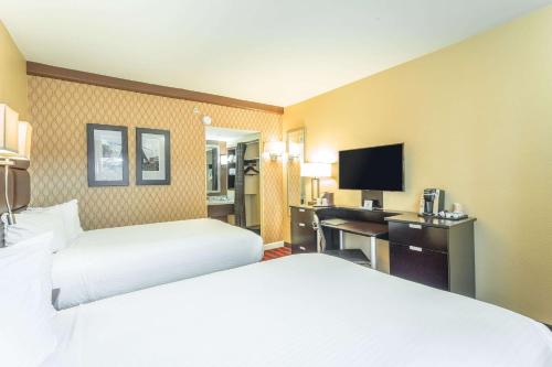 a hotel room with two beds and a flat screen tv at Inn at the Peachtrees, Ascend Hotel Collection in Atlanta