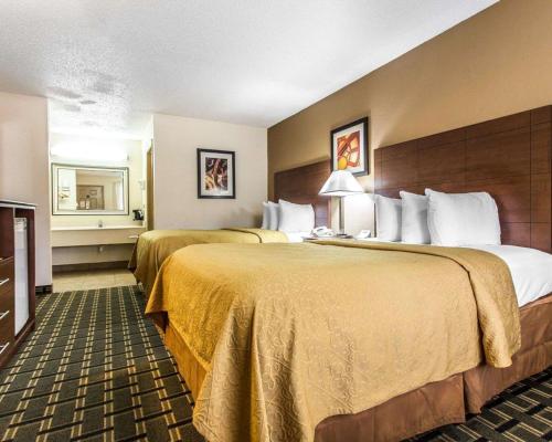 A bed or beds in a room at Quality Inn & Suites Morrow Atlanta South