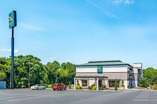 a krispy kreme store with cars parked in a parking lot at Quality Inn Columbus near Fort Benning in Columbus