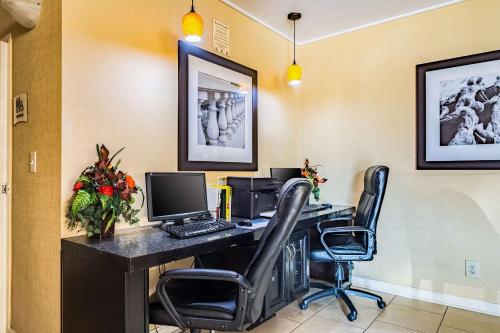 an office with a desk with a computer and two chairs at Quality Inn Columbus near Fort Benning in Columbus