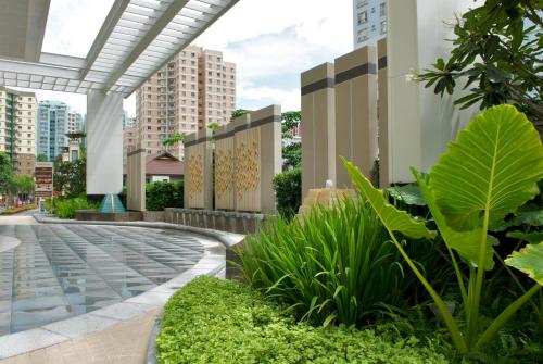a view of a building with plants and buildings at The Narathiwas Hotel & Residence Sathorn Bangkok in Bangkok