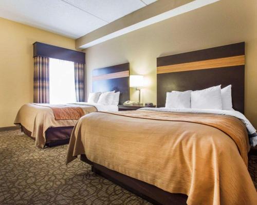 a hotel room with two beds and a window at Comfort Inn & Suites at Stone Mountain in Stone Mountain