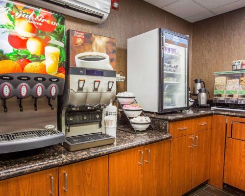 a kitchen counter with a coffee maker and a refrigerator at Comfort Inn & Suites at Stone Mountain in Stone Mountain