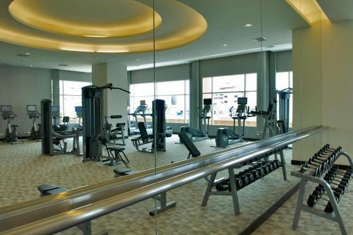 a fitness room with a gym with tread machines at The Narathiwas Hotel & Residence Sathorn Bangkok in Bangkok