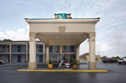 a hotel with a motorcycle parked in a parking lot at Quality Inn Augusta West Near Fort Eisenhower in Augusta