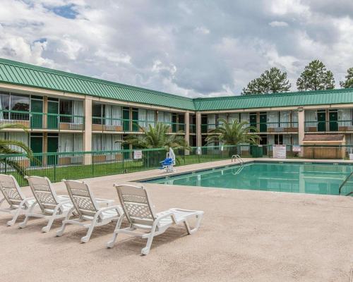 a group of chairs sitting next to a swimming pool at Econo Lodge in Douglas