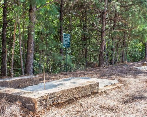 a sign in the middle of a park with trees at Suburban Studios Kennesaw-Marietta North in Kennesaw