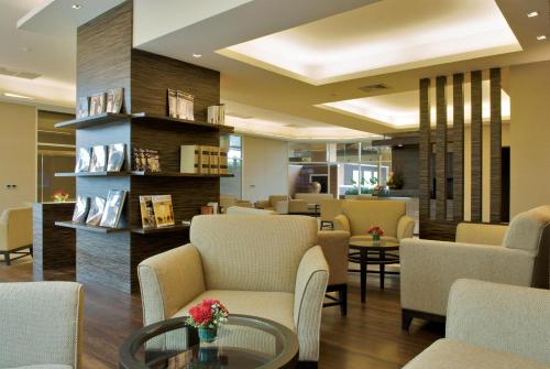 a waiting area in a hospital with chairs and tables at The Narathiwas Hotel & Residence Sathorn Bangkok in Bangkok