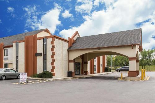 a building with an archway in a parking lot at Econo Lodge At Six Flags in Austell