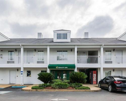 a white building with a car parked in front of it at Quality Inn in Bainbridge