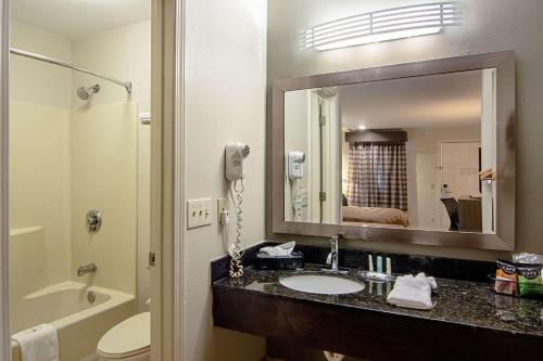 a bathroom with a sink and a mirror at Quality Inn Lagrange in La Grange