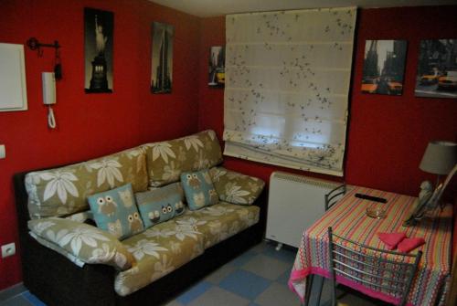 a living room with a couch and a table at Apartahotel Rural CollaRubio Luxury in Collado Mediano